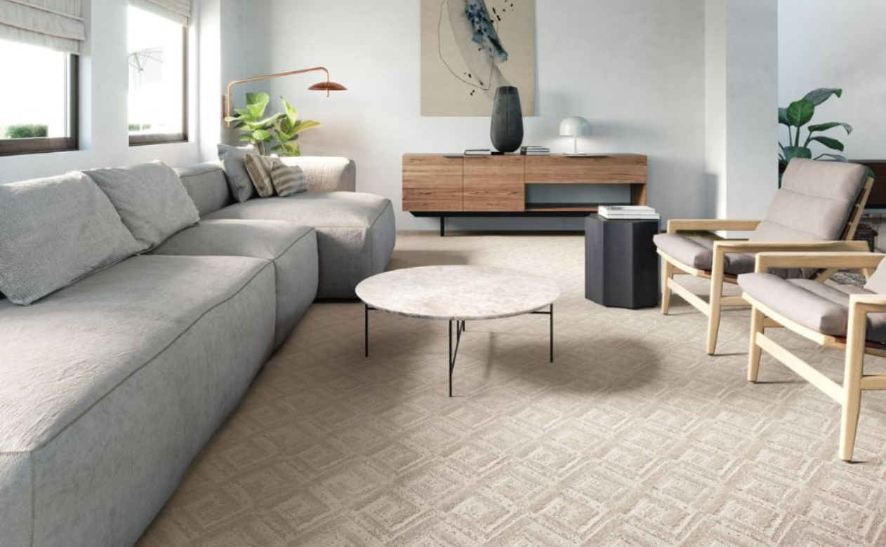 Carpet in living room with coach, chairs, lamp, and wood table